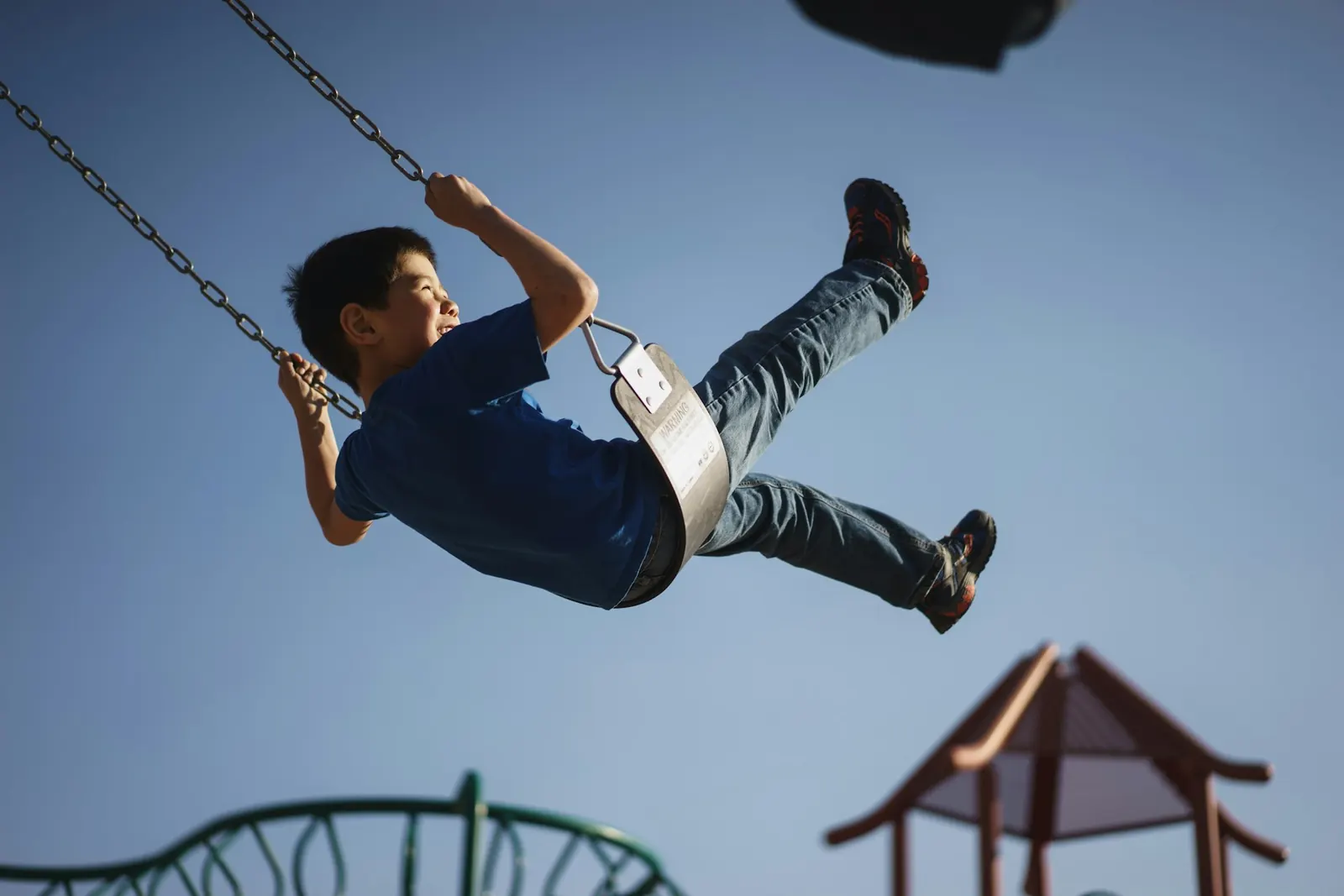 child swinging at playground