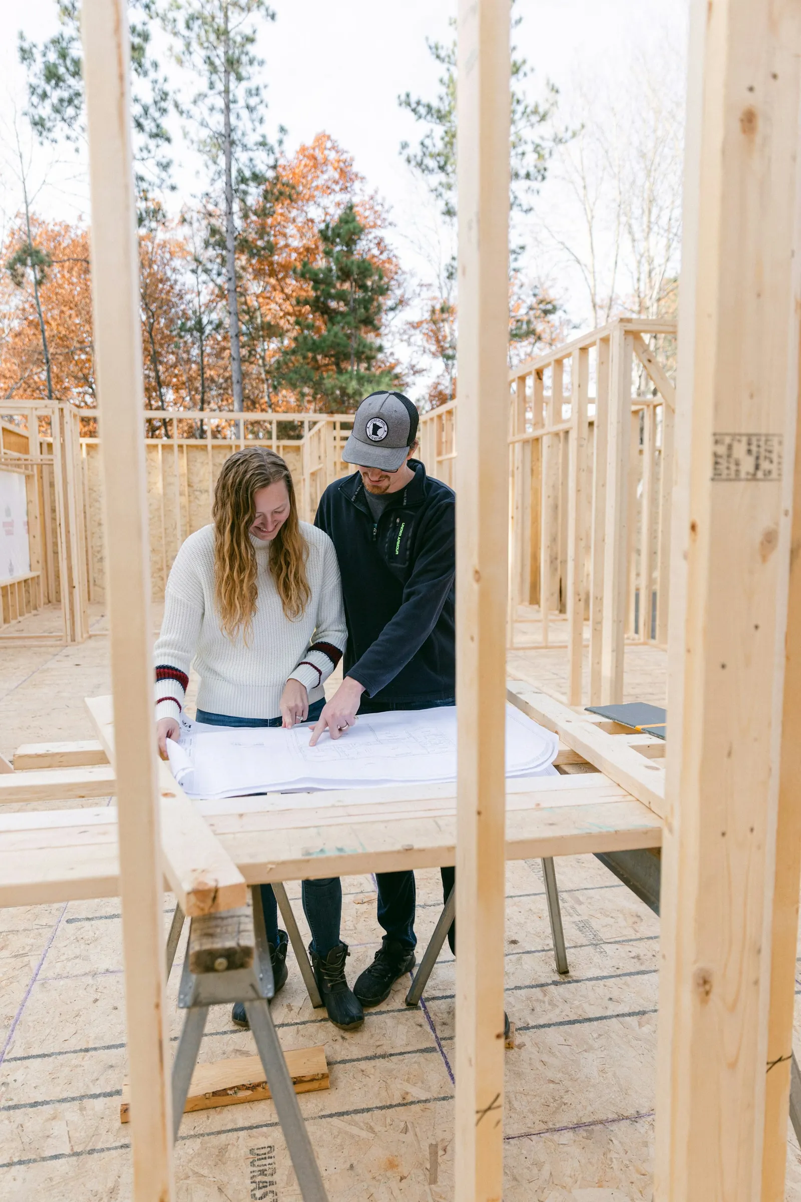 couple reviewing plans in a new construction home