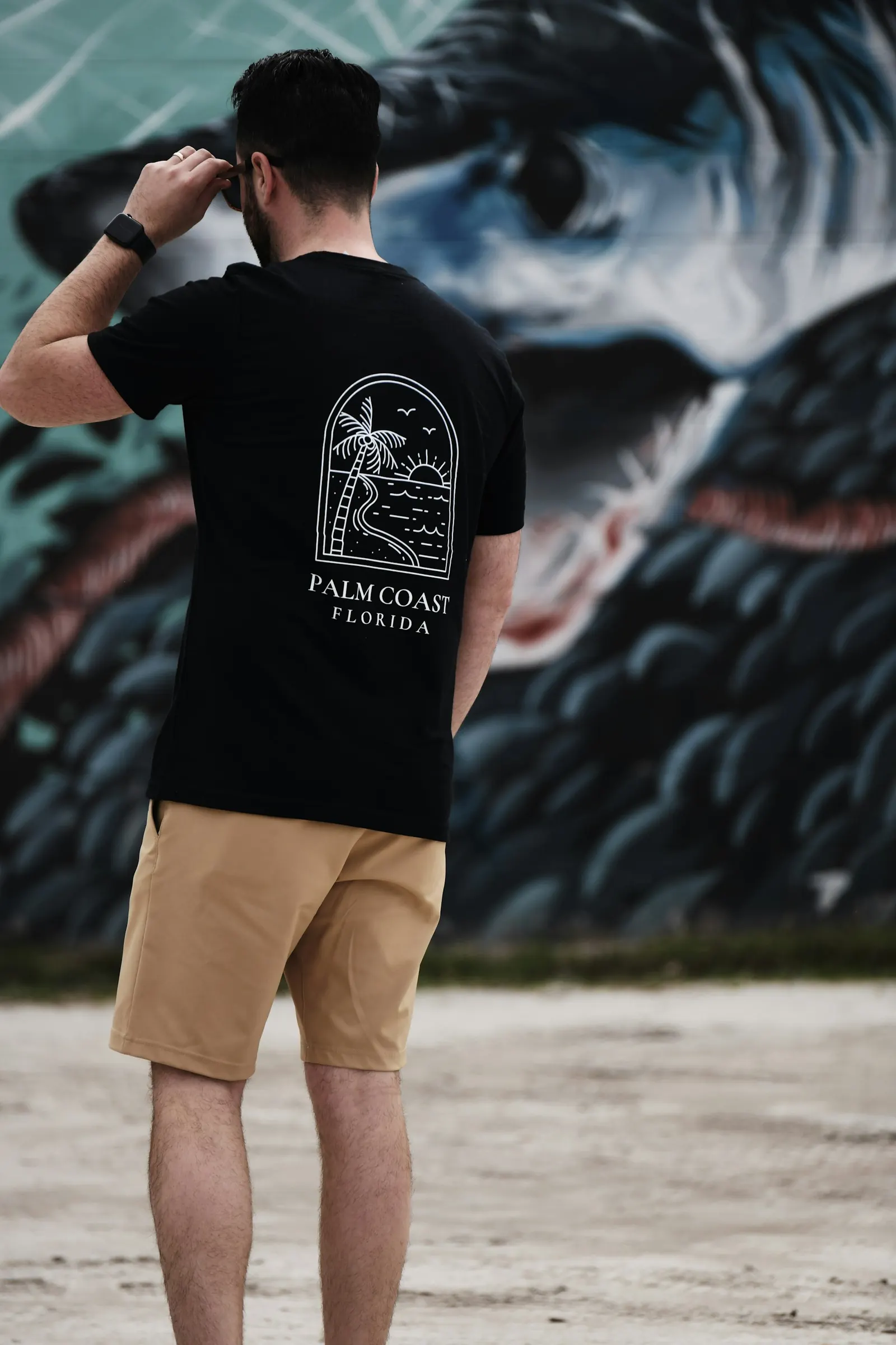 man wearing palm coast florida t shirt