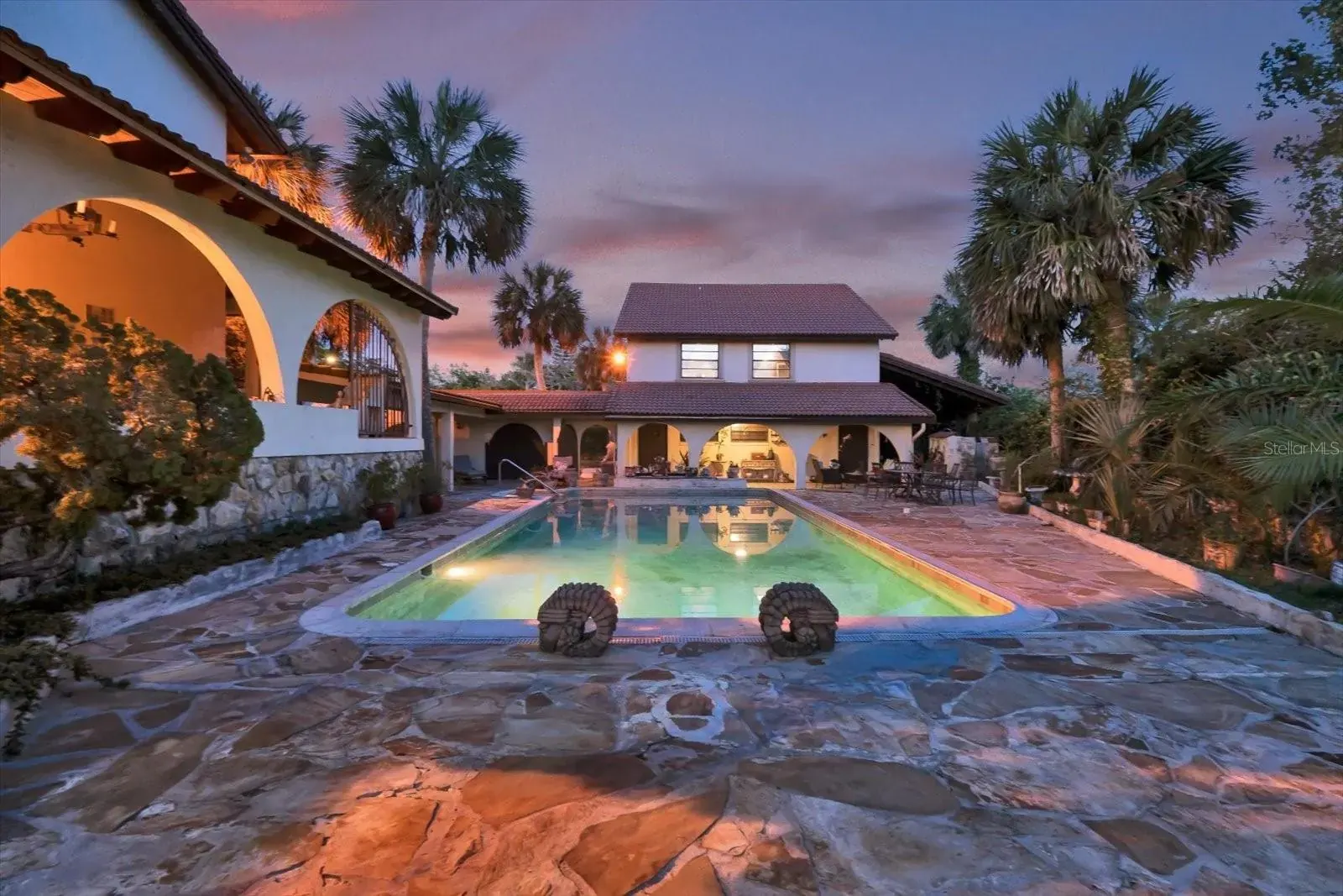 Riverfront estate pool at dusk in Ormond Beach
